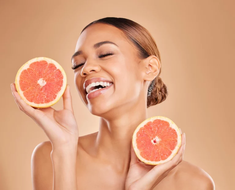 skincare-grapefruit-face-woman-with-laugh-studio-wellness-facial-treatment-natural-cosmetics-beauty-spa-aesthetic-happy-girl-with-fruit-detox-vitamin-c-dermatology