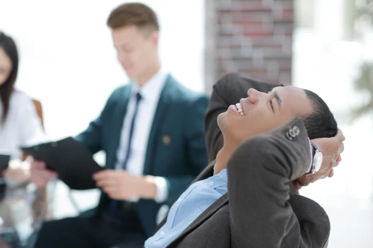 Dreaming businessman on blurred background office photo with copy space