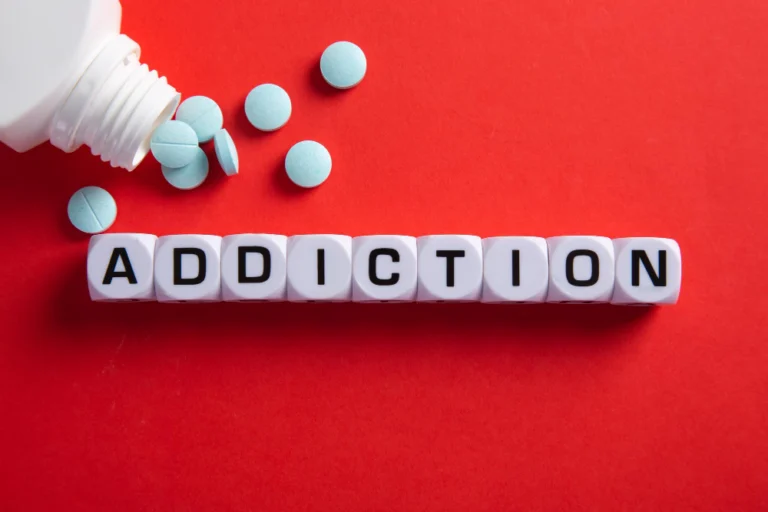 Drug addict or medical abuse concept obsession to pharmaceutical substances or narcotics or anxiety pills medicine spilling out from a bottle on red background