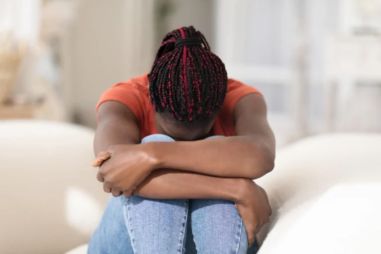 Mental breakdown portrait of upset young african american woman crying at home