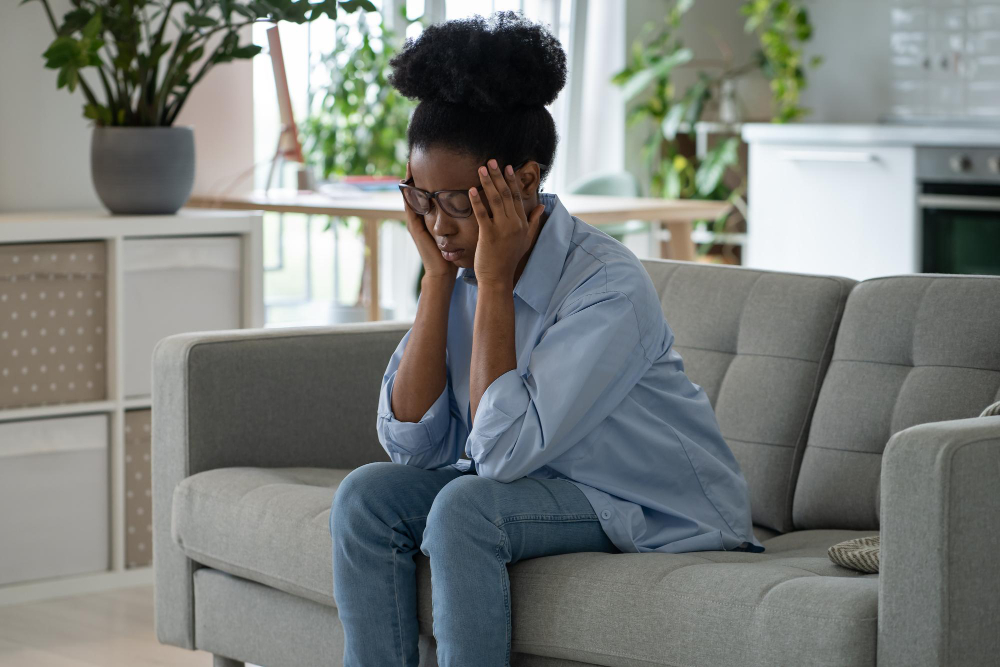 discouraged-sad-african-american-woman-sits-sofa-feeling-stressed-because-loneliness