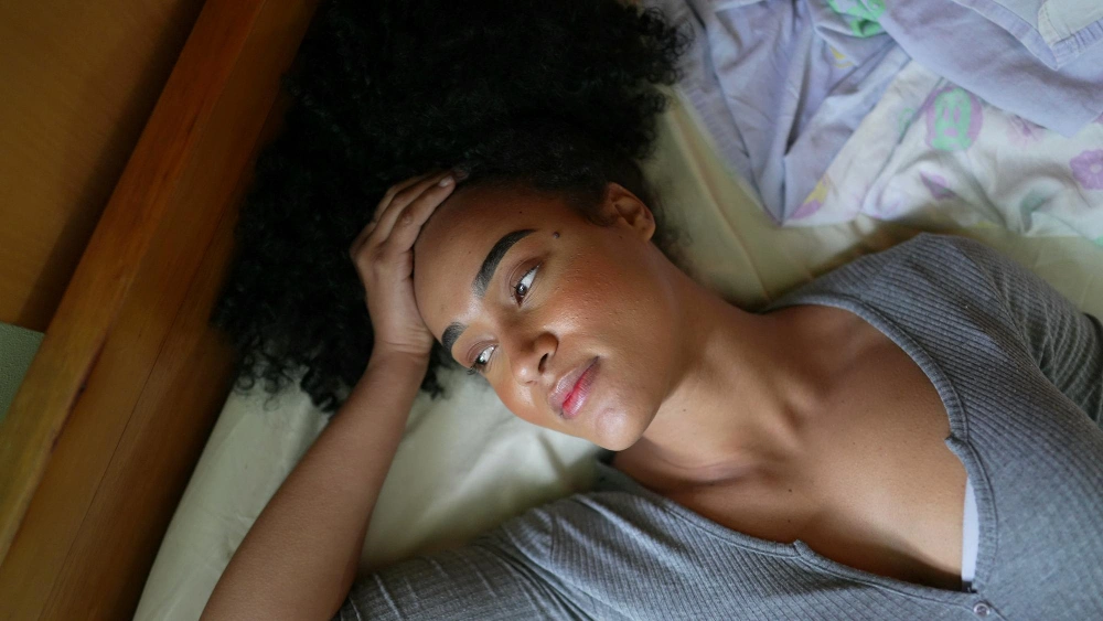 African American woman feeling Insomnia in bed