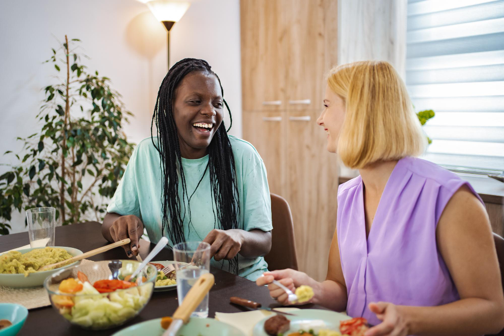 Friends share a joyful meal together in a cozy dining room