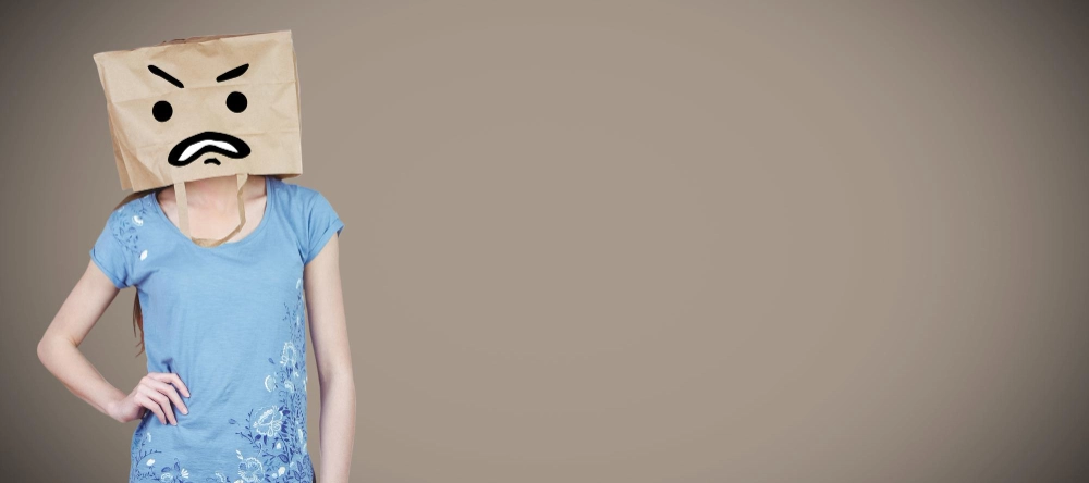 Composite image of woman posing with bag on head